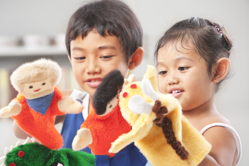 Sibling playing hand puppet